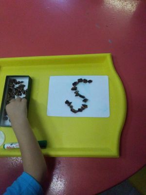 Sound S fine motor skills sand tray - beans drawing